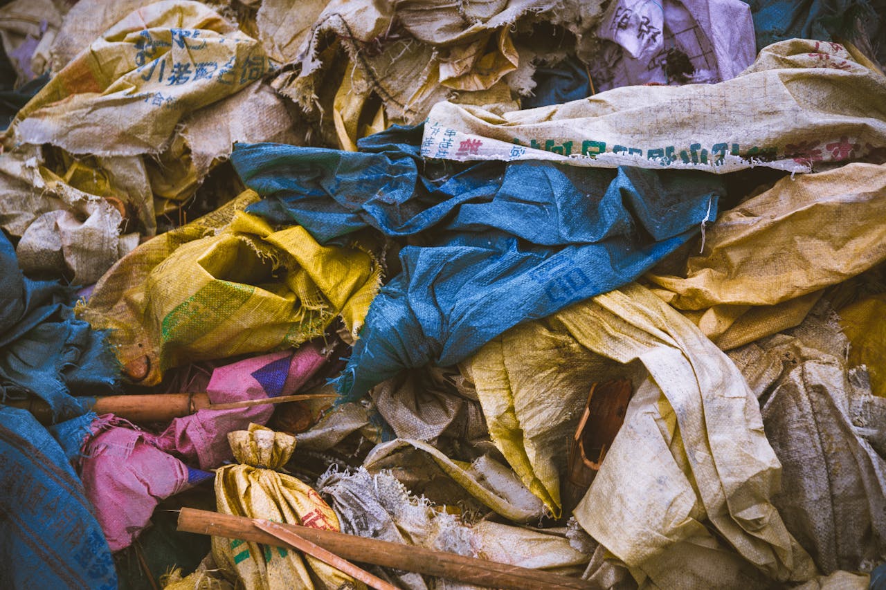 Crafting Captivating Headlines: Your awesome post title goes here A vibrant mix of discarded textile bags in a recycling pile, showcasing the importance of waste management.